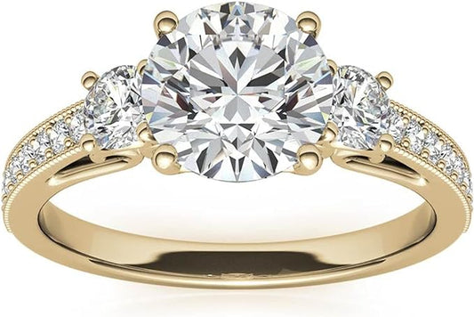 Moissanite Color: Yellow Gold round three-stone design with  accents. Main stone: 1 carat, 2 side stone: 0.5 carat, surrounded by some small moissanite.