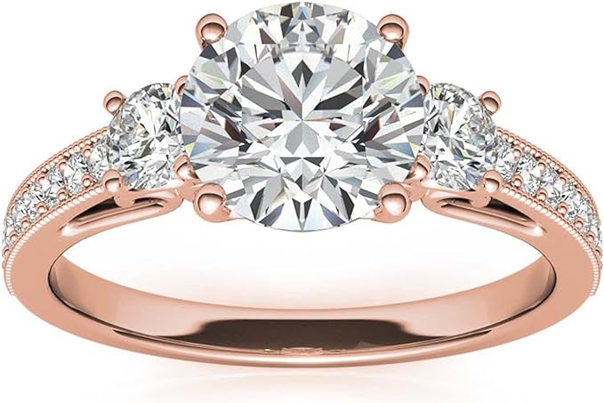 Moissanite Color: Rose Gold round three-stone design with  accents. Main stone: 1 carat, 2 side stone: 0.5 carat, surrounded by some small moissanite.